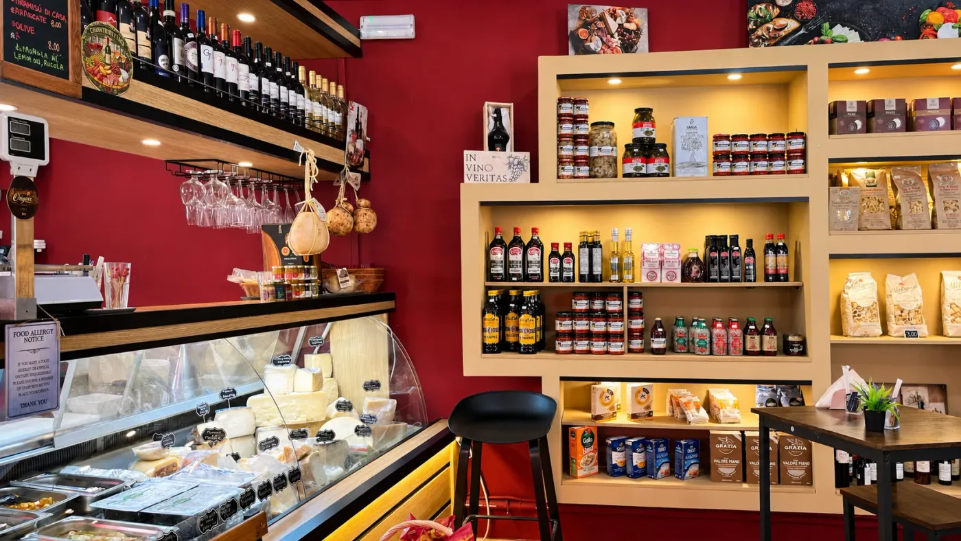 Inside Origini Salumeria: shelves of wine, preserves and cheese